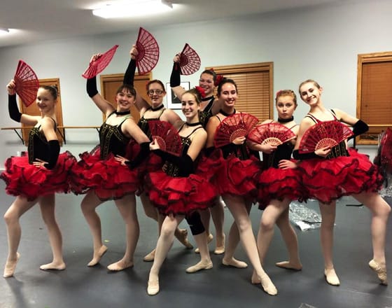 Girls dressed in red tutus for dance class